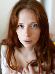 Redhead babe Zazi Darling can't keep her hands off her all natural tits or her flat belly! Her clothes come off as she feels herself up, letting 