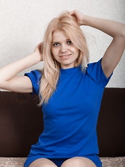 Amuza strips off blue dress to pose naked on bed