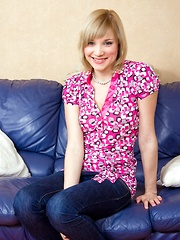 A cute teenage hottie masturbating on the big blue couch