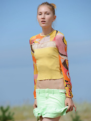 The hot sun burns her pale skin as she shows of her gorgeous form in some hot poses, while being naked and naughty.