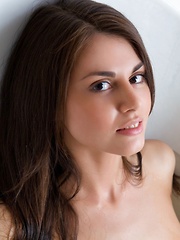 Astrud A playfully posing before taking a dip in the bathtub.